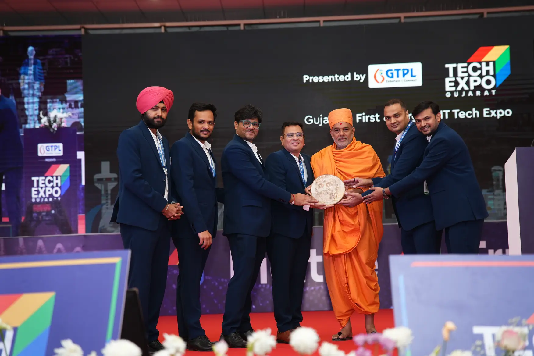 Tejas Shah, founder of MagnusMinds IT Solutions, meeting with gyanvatsal swami at TechExpo Gujarat 2024 as an organizer